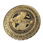 Angel Aberdeen – Human Being Coin in brass – back engraved with Not Alone, surrounded by people holding hands around the globe, additional words including Love, Suffering, Forgiveness, and I'm Okay