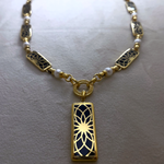 Angel Aberdeen – Forever Connected station necklace – 18k PVD gold plated with black enamel inlay and pearls – front view with sacred geometric torus pendant and linked design