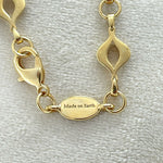 Elegant 14K gold-plated mandorla chain symbolizing divine feminine unity.
Handcrafted, engraved “Made on Earth.” A sacred geometry necklace.