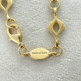 Elegant 14K gold-plated mandorla chain symbolizing divine feminine unity.
Handcrafted, engraved “Made on Earth.” A sacred geometry necklace.