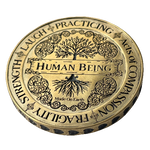 Angel Aberdeen – Human Being Coin in brass – front of coin engraved with Human Being, Fragility, and Acts of Compassion