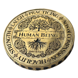 Angel Aberdeen – Human Being Coin in brass – front of coin engraved with Human Being, Fragility, and Acts of Compassion