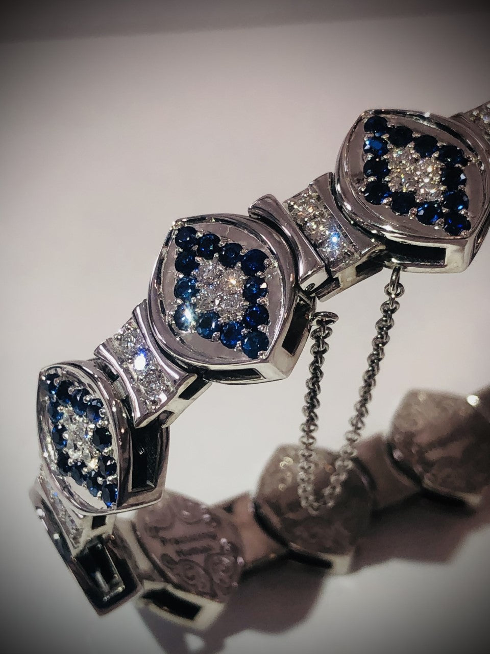 Elegant 14KT white gold bracelet with sapphires and diamonds from the Angel Aberdeen Sacred Mandorla Collection, photographed under soft light.