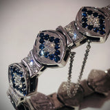 Elegant 14KT white gold bracelet with sapphires and diamonds from the Angel Aberdeen Sacred Mandorla Collection, photographed under soft light.
